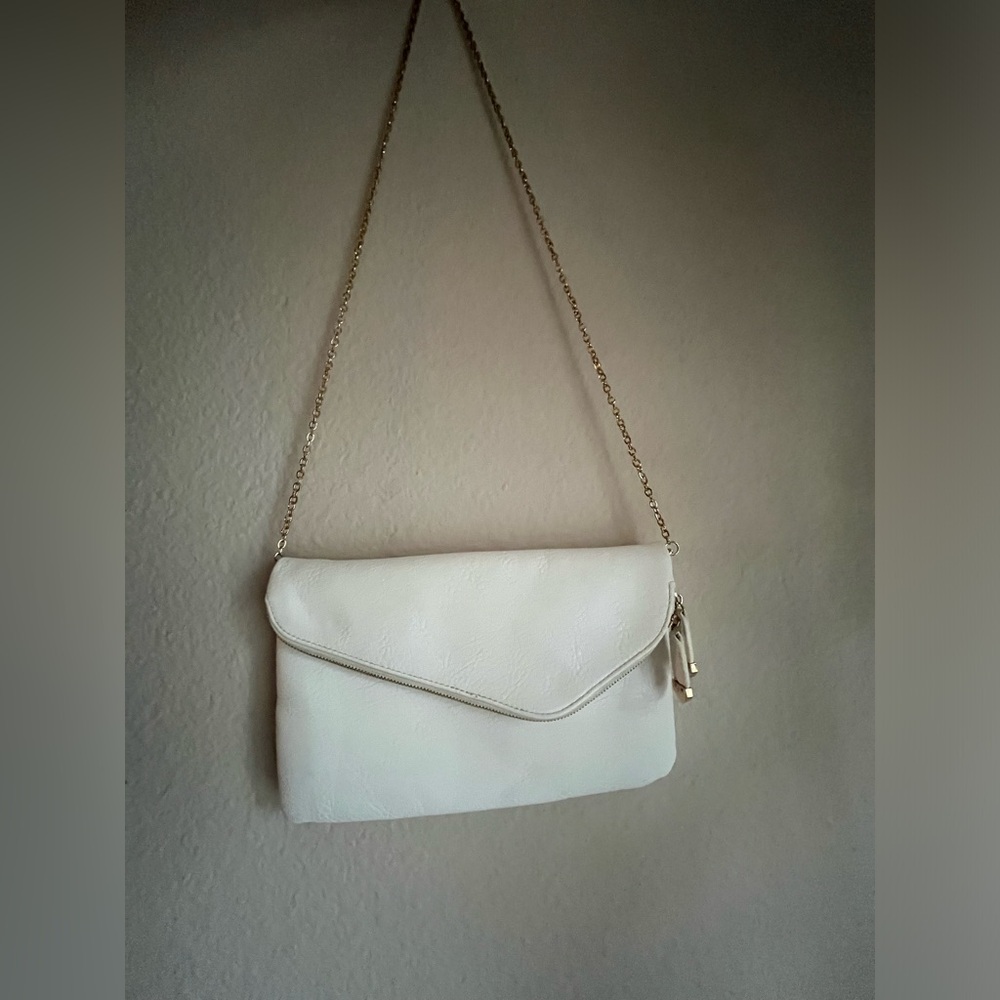 Lulus white crossbody bag/ clutch with gold details.